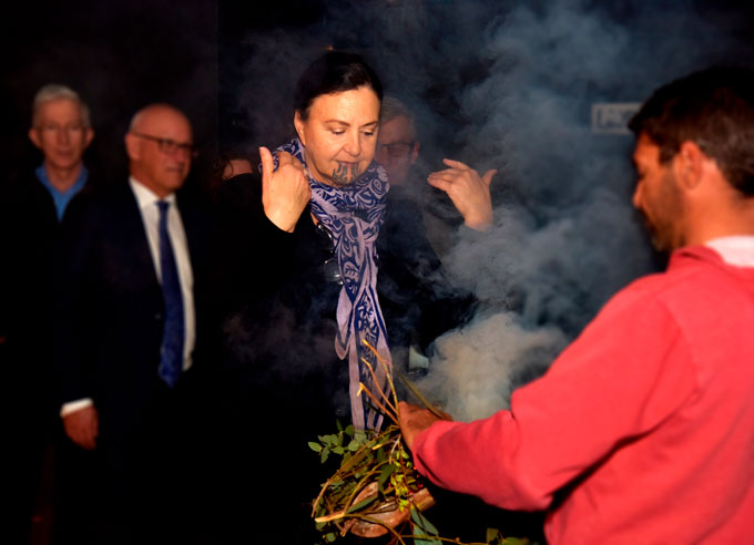 Photo of AMC Māori Member, Professor Papaarangi Reid, participating in the smoking ceremony with Jay Daley
